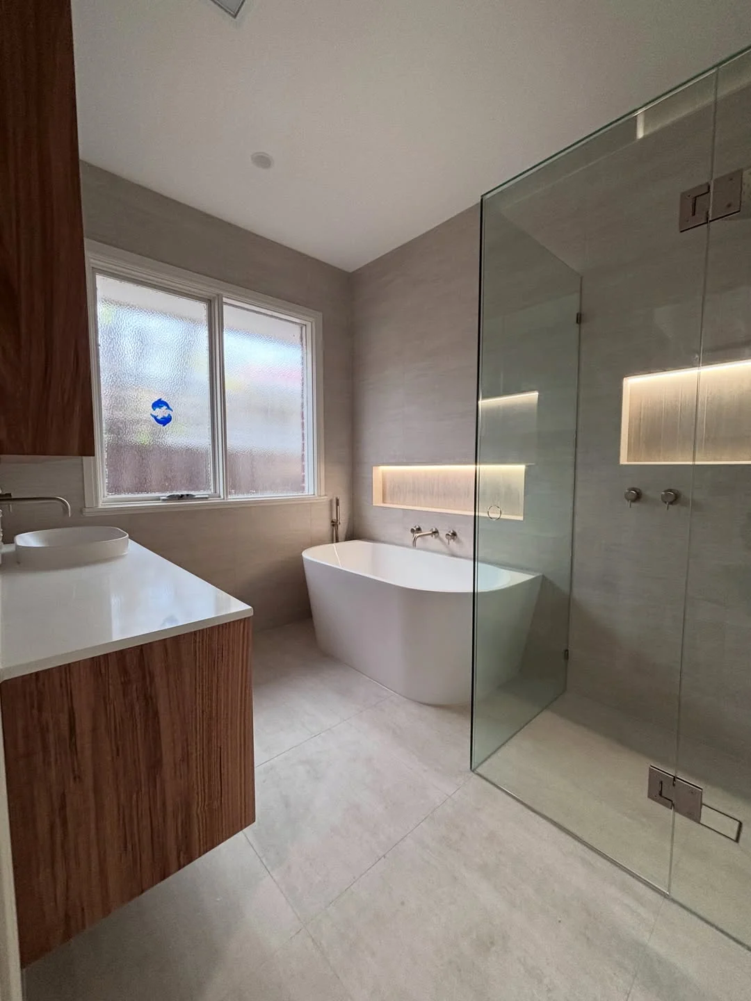 Sandringham bathroom with timber vanity, freestanding bath and glass shower